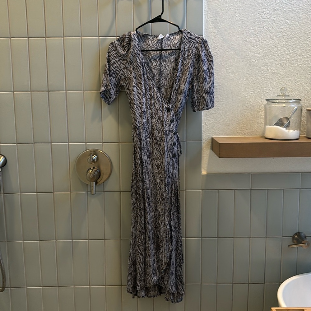 Beautiful dot-printed wrap dress with button detail.